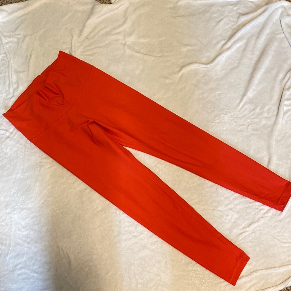 Bright dark coral high waisted workout leggings.